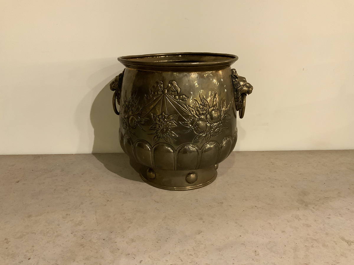 Large English Victorian Brass Jardiniere with Floral, Ribbon and Swag Repousse Decoration and Brass Lion‘s Head Ring Handles.